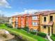 Exterior view of multi-Gathering building with a pond and a small bridge at 5164 Conroy Rd # 1526, Orlando, FL 32811