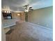 Open-concept living room with breakfast bar and neutral color scheme at 5164 Conroy Rd # 1526, Orlando, FL 32811
