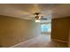 A spacious living room features a ceiling fan and neutral carpeting at 5164 Conroy Rd # 1526, Orlando, FL 32811