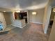 Open living space and kitchen with carpet, tile, and modern lighting at 5164 Conroy Rd # 1526, Orlando, FL 32811