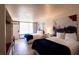 Bright hotel room with two beds, white linens, unique artwork, and hardwood floors at 5245 W Irlo Bronson Memorial Hwy # 151, Kissimmee, FL 34746