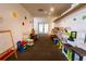Colorful playroom with various toys, books, and a miniature play kitchen at 5245 W Irlo Bronson Memorial Hwy # 151, Kissimmee, FL 34746