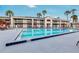 Outdoor pool with lounge area offering a relaxing view of the apartment complex at 5245 W Irlo Bronson Memorial Hwy # 151, Kissimmee, FL 34746