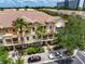 Aerial view of townhomes showing garages, balconies, landscaping, and nearby parking at 724 Greybull Run, Lake Mary, FL 32746