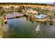 Aerial view showcasing the community clubhouse, pool, lake, and fountains in a picturesque setting at 724 Greybull Run, Lake Mary, FL 32746