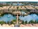 Stunning aerial view of condos surrounding a central pond, clubhouse, and pool area at 724 Greybull Run, Lake Mary, FL 32746
