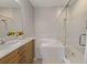 Bright bathroom featuring a soaking tub, walk-in shower and stylish vanity with stone countertops at 724 Greybull Run, Lake Mary, FL 32746