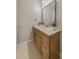 Bathroom featuring a mirror, sink with stone countertops and wood cabinets at 724 Greybull Run, Lake Mary, FL 32746