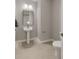 Elegant powder room featuring a pedestal sink, modern lighting, and a toilet at 724 Greybull Run, Lake Mary, FL 32746
