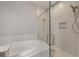 Bright bathroom featuring a soaking tub, walk-in shower and tiled walls at 724 Greybull Run, Lake Mary, FL 32746