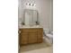 Bathroom features a wood vanity, neutral countertops, and a large mirror with modern lighting at 724 Greybull Run, Lake Mary, FL 32746