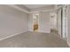 Inviting bedroom featuring soft carpet, tray ceiling, and en suite bathroom access at 724 Greybull Run, Lake Mary, FL 32746