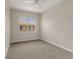 This empty bedroom features neutral paint, carpet, ceiling fan and a view to the neighboring building at 724 Greybull Run, Lake Mary, FL 32746