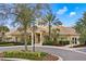 Community clubhouse surrounded by lush landscaping, including palm trees and manicured shrubs at 724 Greybull Run, Lake Mary, FL 32746