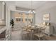 Cozy dining area featuring a chandelier, table with seating, and a bar overlooking the kitchen at 724 Greybull Run, Lake Mary, FL 32746