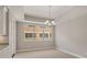 Bright dining room with large window, tile flooring, and modern chandelier at 724 Greybull Run, Lake Mary, FL 32746