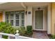 Inviting townhome entrance features a green door, brick walkway, and lovely landscaping at 724 Greybull Run, Lake Mary, FL 32746