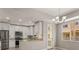Open kitchen concept featuring white cabinets, stainless steel appliances, granite countertops, and a door to outdoor area at 724 Greybull Run, Lake Mary, FL 32746