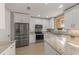Modern kitchen features stainless steel appliances, recessed lighting, and granite countertops at 724 Greybull Run, Lake Mary, FL 32746