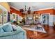 Inviting living room with wood floors, a ceiling fan, and a decorative entertainment center at 724 Greybull Run, Lake Mary, FL 32746