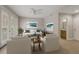 Bright living room boasts tile floors, white furniture, decorative pillows, wall art and a ceiling fan at 724 Greybull Run, Lake Mary, FL 32746