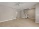 Neutral living room with tile flooring and staircase, offering versatile living and entertaining space at 724 Greybull Run, Lake Mary, FL 32746
