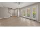 Bright living room boasts tile floors, neutral walls, white trim, and a glass-paneled door at 724 Greybull Run, Lake Mary, FL 32746