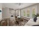 Bright living room boasts tile floors, white furniture, large windows with natural light, and an area rug at 724 Greybull Run, Lake Mary, FL 32746