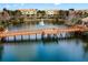 Scenic aerial view of a lake with a wooden boardwalk and community buildings at 724 Greybull Run, Lake Mary, FL 32746