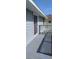 Cozy back porch with lattice and painted wood with sliding glass door access to the home at 9315 9Th Ave, Orlando, FL 32824