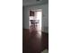 View of dining area adjacent to living room, featuring hardwood floors and kitchen view at 9315 9Th Ave, Orlando, FL 32824