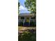 Charming home featuring a bright yellow front door, a cozy porch and a well-maintained lawn at 9315 9Th Ave, Orlando, FL 32824