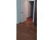 Hardwood floors in hallway with open doorway at 9315 9Th Ave, Orlando, FL 32824