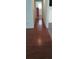 Long hallway featuring hardwood floors and neutral walls connecting the living spaces at 9315 9Th Ave, Orlando, FL 32824