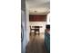 A compact kitchen featuring stylish cabinets, an adjacent dining area, and updated flooring at 9315 9Th Ave, Orlando, FL 32824