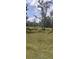 A picturesque lot surrounded by lush trees under a partly cloudy sky at 9315 9Th Ave, Orlando, FL 32824