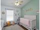 Cozy Bedroom with ample natural light, a comfortable chair, and a whimsical animal theme at 1023 Royal Oaks Dr, Apopka, FL 32703