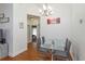 Bright dining room with glass table, modern chandelier, and views into other rooms at 1023 Royal Oaks Dr, Apopka, FL 32703