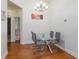 Modern dining room with a glass table, gray chairs, and laminate wood flooring at 1023 Royal Oaks Dr, Apopka, FL 32703