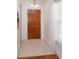 Inviting foyer features tile flooring and a wooden front door, with natural light coming through a window at 1023 Royal Oaks Dr, Apopka, FL 32703