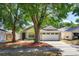 Charming single-story home with well-maintained lawn and mature trees providing ample shade at 1023 Royal Oaks Dr, Apopka, FL 32703
