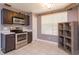 Well-lit kitchen with stainless steel appliances, a window with blinds, and tile flooring at 1023 Royal Oaks Dr, Apopka, FL 32703