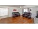 Open living room with two sofas, a ceiling fan, wood-look floors and a large window at 1023 Royal Oaks Dr, Apopka, FL 32703