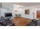 Comfortable living area featuring dark wood floors, ceiling fan, and a view into the kitchen at 1023 Royal Oaks Dr, Apopka, FL 32703