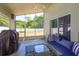Relaxing screened patio with a comfortable seating area, perfect for outdoor enjoyment at 1023 Royal Oaks Dr, Apopka, FL 32703