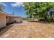 Expansive backyard with mature trees and partial fencing, offering ample outdoor space at 1084 Doyle Rd, Deltona, FL 32725
