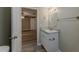 View from bathroom to bedroom with granite countertop and wood flooring at 1084 Doyle Rd, Deltona, FL 32725