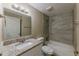 Updated bathroom with granite vanity, tub, and shower combo featuring tiled wall at 1084 Doyle Rd, Deltona, FL 32725