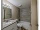 Updated bathroom with granite vanity, tub, and shower combo featuring tiled wall at 1084 Doyle Rd, Deltona, FL 32725
