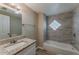 Bathroom with a tub and shower, granite countertop, and tile accents at 1084 Doyle Rd, Deltona, FL 32725